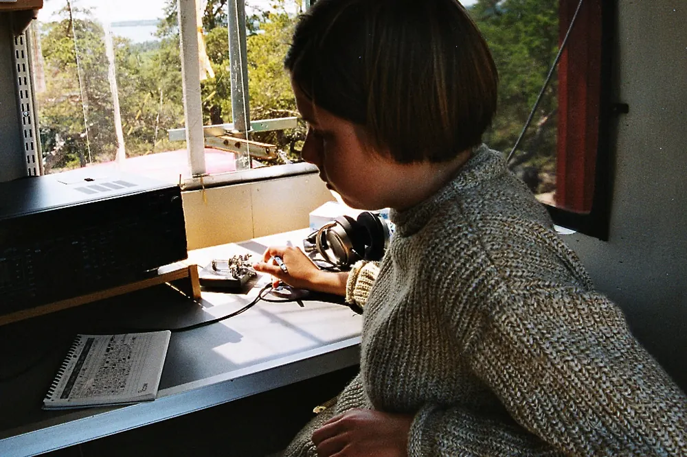 An operator sending Morse code with an electronic keyer and twin-lever paddle